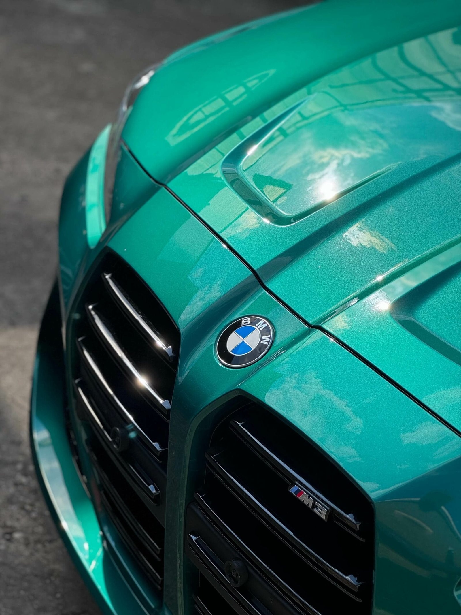 Motorhaube eines BMW M4 mit Reflexionen